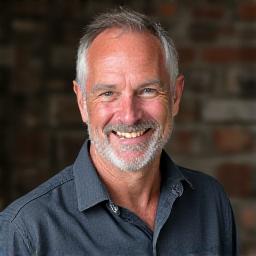 Portrait of Liam O'Brien, Lead Blacksmith, smiling professionally